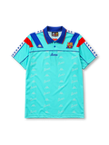 Barcelona 1992-95 away jersey, front view, mint turquoise body with repeated Barca script pattern, blue polo-style collar, red and blue diagonal shoulder panels, Kappa logo, Barcelona crest, blue Barca script wordmark