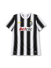 Juventus 2011-12 home jersey, front view, black and white vertical stripes with halftone edges, white crew neck collar, gold Nike swoosh on right chest, oval Juventus crest with two gold stars on left chest, BETCLIC sponsor logo on white panel, DRI-FIT print and Nike Authentic tag at hem