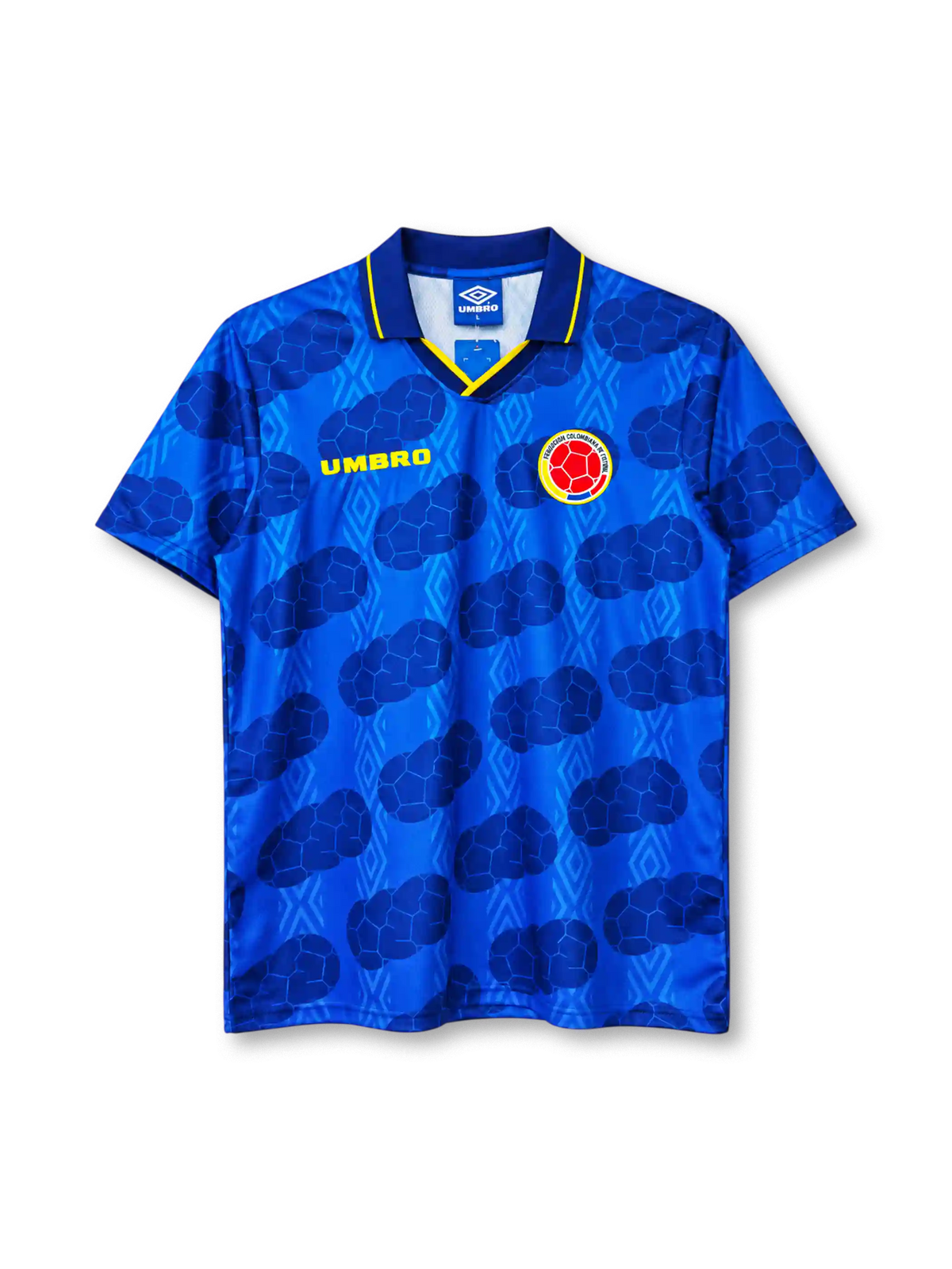 Colombia 1994 away jersey, front view, royal blue body with tonal diamond pattern and darker football-panel print, navy polo collar with yellow tipping and V insert, yellow UMBRO wordmark on right chest, Colombian Football Federation crest on left chest
