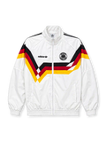 Front view of a white Germany 1990 World Cup retro track jacket featuring black, red, and gold chevron graphics across the chest and sleeves, a black adidas Trefoil logo, circular DFB crest, stand-up collar, full zipper, and elasticated cuffs.