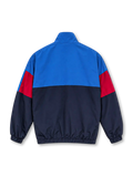 Front view of the FC Barcelona 1899 vintage track jacket featuring an electric blue upper body, navy lower panels, red sleeve accents, embroidered-style Barcelona crest, high stand-up collar, black front zipper, side pockets, and elasticated cuffs.