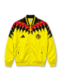 Front view of the adidas Club América 2026/27 Stadium Track Top in bright yellow, featuring a red and black geometric graphic across the shoulders and chest, black adidas performance logo, Club América crest, contrasting V-neck collar, full-length zipper, and zippered front pockets.