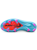 Nike Mercurial FG soccer cleats in light blue with multicolor confetti speckles, a black-outlined silver Swoosh, an orange painted toe graphic, an oversized M heel logo, and pink-tipped studs, shown as a pair.