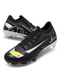 Nike Mercurial FG soccer cleats in black with multicolor confetti speckles, a metallic silver Swoosh, a yellow and pink painted toe graphic, white Air Zoom heel lettering, and an oversized M heel logo, shown as a pair.