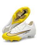 Nike Mercurial FG soccer cleats in white with a yellow toe fade, a black-outlined metallic gold Swoosh, and Air Zoom side lettering, plus a yellow soleplate with a gold Air Zoom window, shown from the lateral side and outsole.