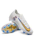 White Nike Mercurial-style FG soccer cleats with a Real Madrid crest, metallic gold Swoosh outlined in blue, and iridescent outsole with blue studs.