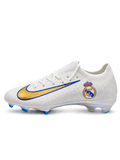 White Nike Mercurial-style FG soccer cleats with a Real Madrid crest, metallic gold Swoosh outlined in blue, and iridescent outsole with blue studs.