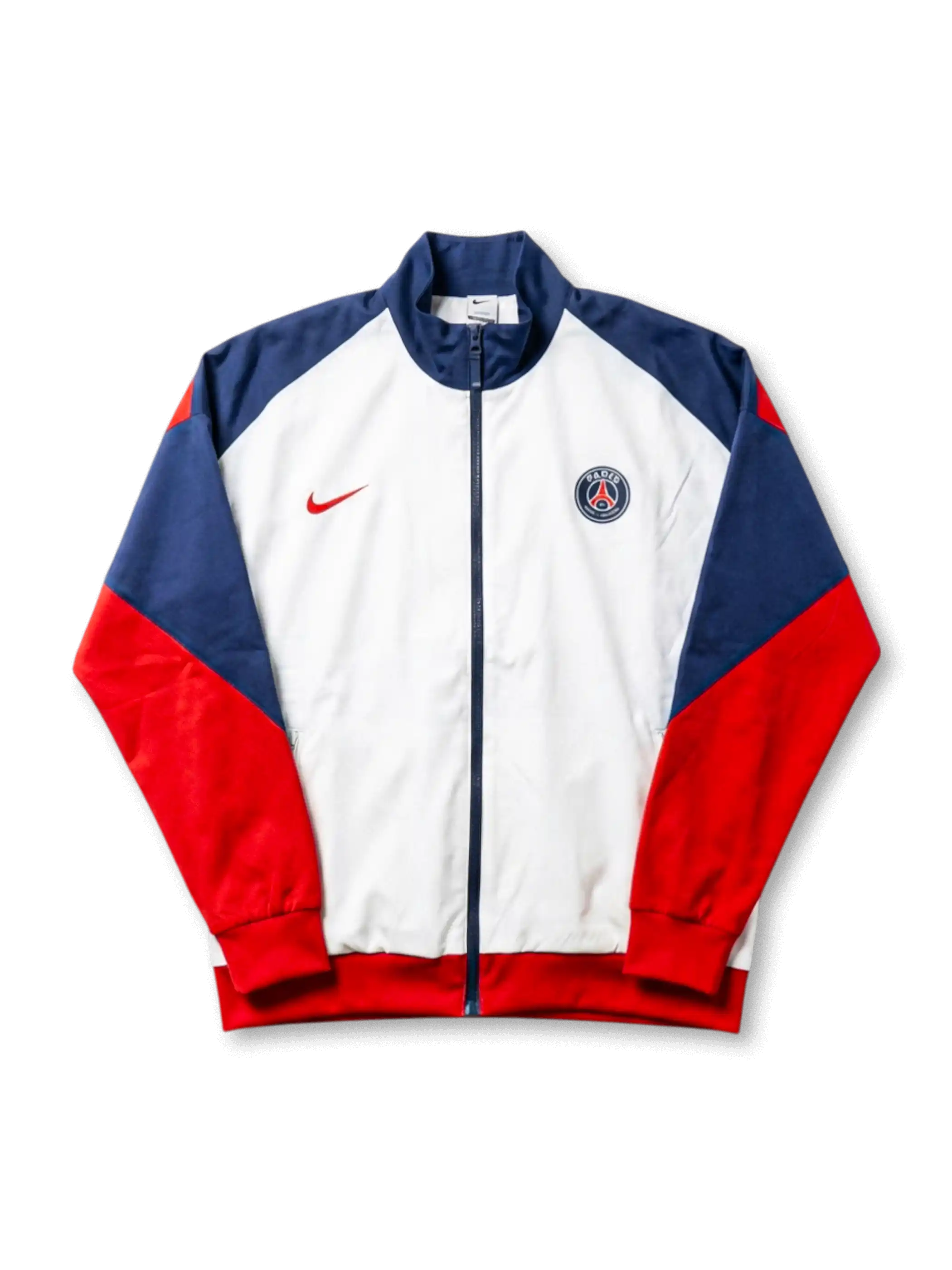 Paris Saint-Germain Nike track jacket with white body, navy raglan shoulder panels, red sleeves, red Nike Swoosh at left chest, and embroidered PSG crest at right chest