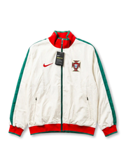 Deadstock Portugal national team Nike training track jacket in white with green sleeves, red and green ribbed collar and cuffs, embroidered FPF crest at right chest, red Swoosh at left, original tags attached