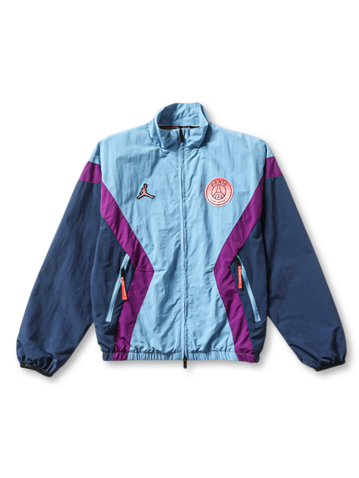 Paris Saint-Germain × Jordan Brand track jacket in ice blue with diagonal purple chevron panels, Jumpman logo at left chest, coral PSG crest badge at right chest, navy sleeves