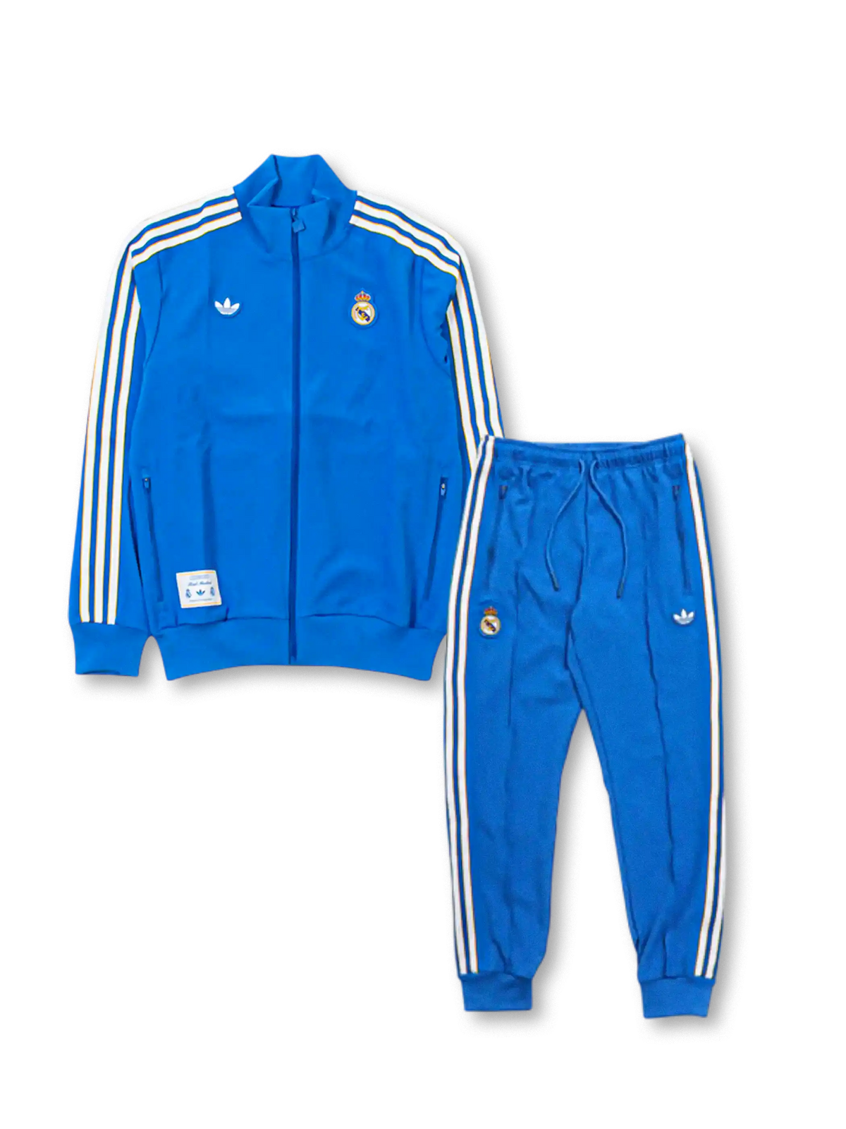 Real Madrid adidas Originals Terrace Icons tracksuit in royal blue with off-white Three Stripes on jacket and pants, embroidered Real Madrid crests, Trefoil logo, and co-branded woven label patch at jacket hem