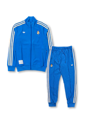 Real Madrid adidas Originals Terrace Icons tracksuit in royal blue with off-white Three Stripes on jacket and pants, embroidered Real Madrid crests, Trefoil logo, and co-branded woven label patch at jacket hem