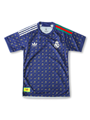 Front view of Real Madrid special edition shirt in navy with gold monogram pattern, crest, trefoil-style chest logo, and striped shoulder detail.