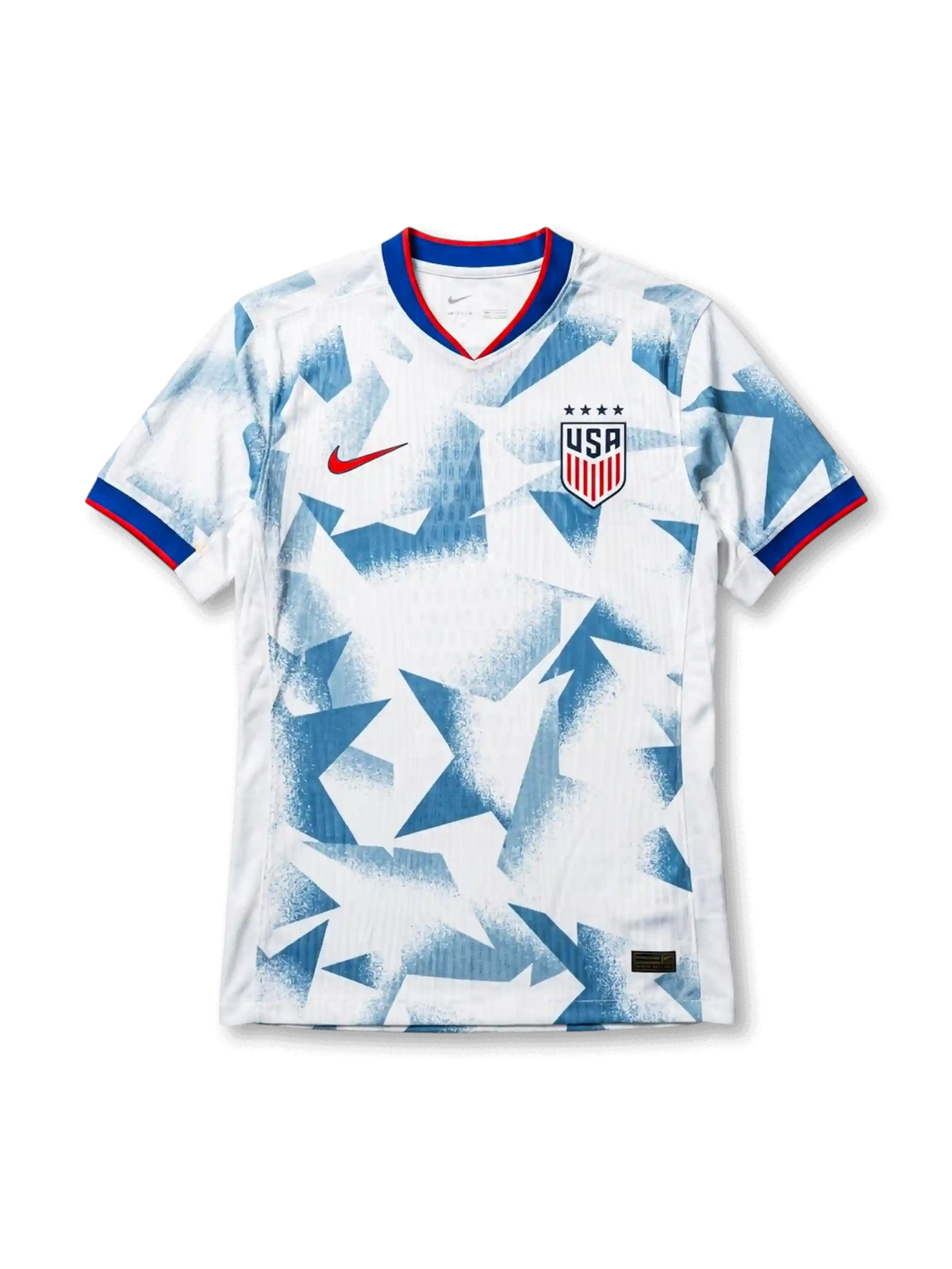 USA national team Nike 2025/26 World Cup home jersey in white with full-surface angular geometric grey shatter-camo print, tricolor V-neck collar in red and blue, red Swoosh at left chest, USA shield crest at right chest, red and blue sleeve cuff bands