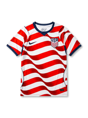 USA national team Nike 2026/27 home jersey in white with full-body wavy red and white stripe pattern, navy V-neck collar, navy curved side panels, navy Swoosh at left chest, USA shield crest at right chest, navy sleeve cuff bands