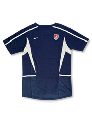 USA national team Nike training jersey in navy with white mesh side panels, white shoulder piping, Nike Swoosh at left chest, embroidered US Soccer shield crest at right chest